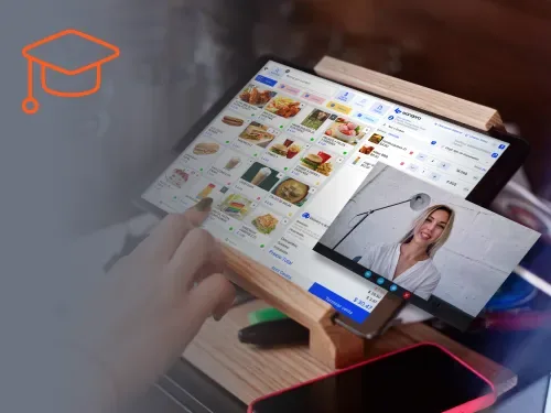 Videotutorial de Wanqara Academy en la tablet junto al punto de venta de un restaurante